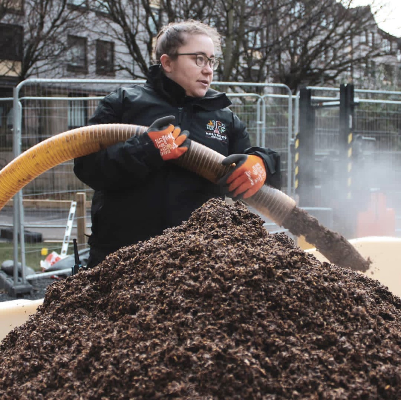 Elizabeth a distiller at Holyrood Distillery in Edinburgh stands with waste malt 