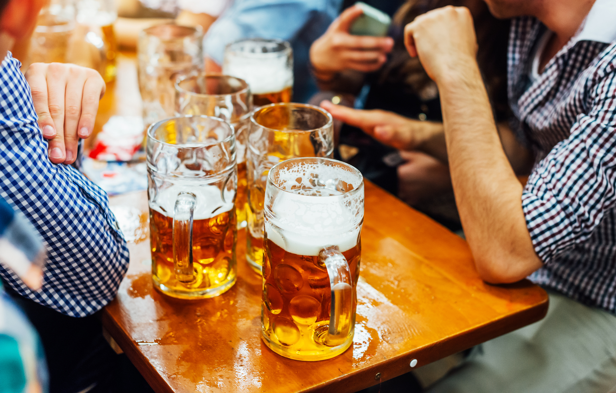 People sitting at a table drinking beer that has been brewed with Maris Otter heritage malt on National Beer Day