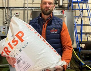 Meet Josh Wurzbacher our Technical Sales Manager in the USA, holding a malt sack in a brewery.