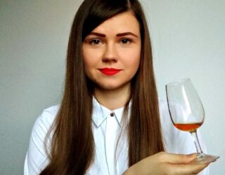 Dr Rutele Marciulionyte head shot holding a whisky glass