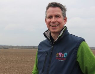 An image of Bill Smith in a field discussing sustainable farming