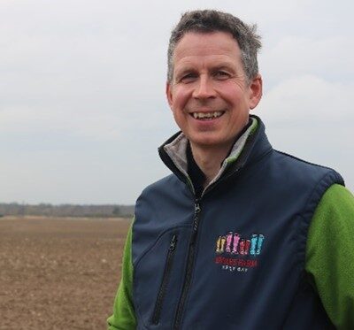 An image of Bill Smith in a field discussing sustainable farming